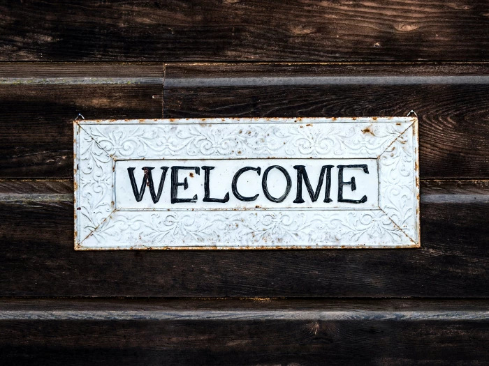 black and white wooden welcome sign