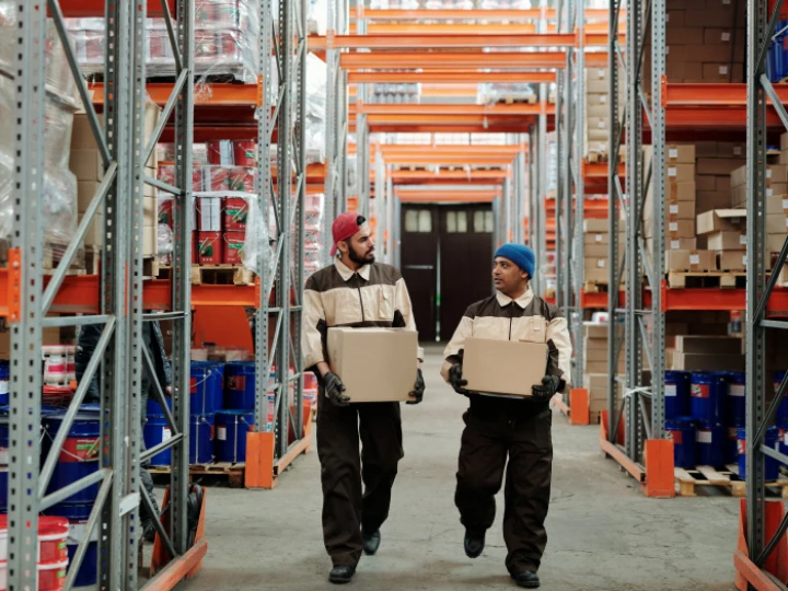 Warehouse Workers Carrying Boxes