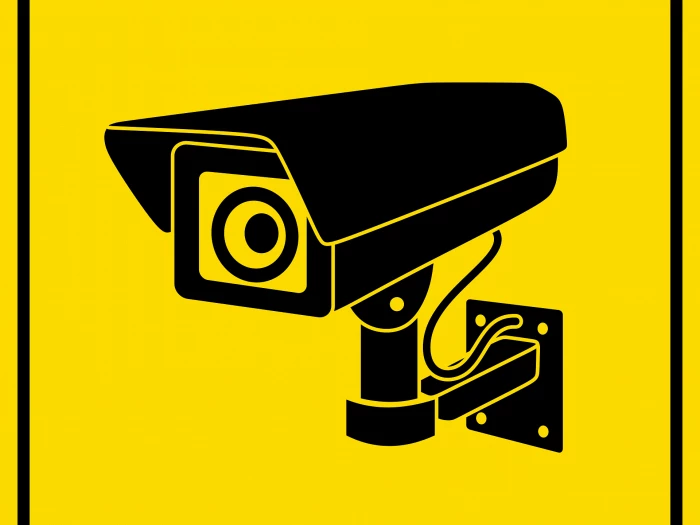 CCTV camera black on yellow