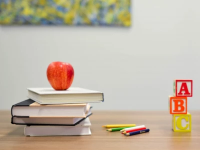 Red apple on desk with books