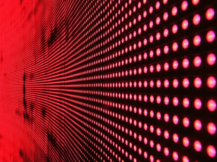 Vibrant abstract pattern of illuminated red LED lights forming a dynamic design.