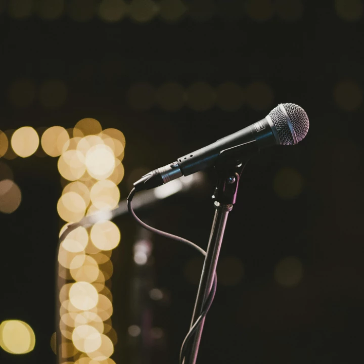 Selective Focus Photography Of Microphone On Microphone Stand