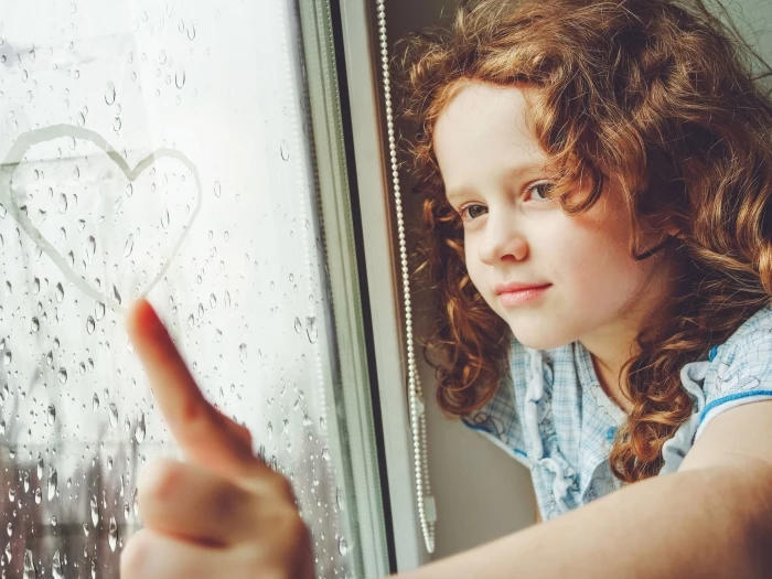 child-at-window-in-rain