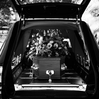 coffin-in-hearse-with-flowers