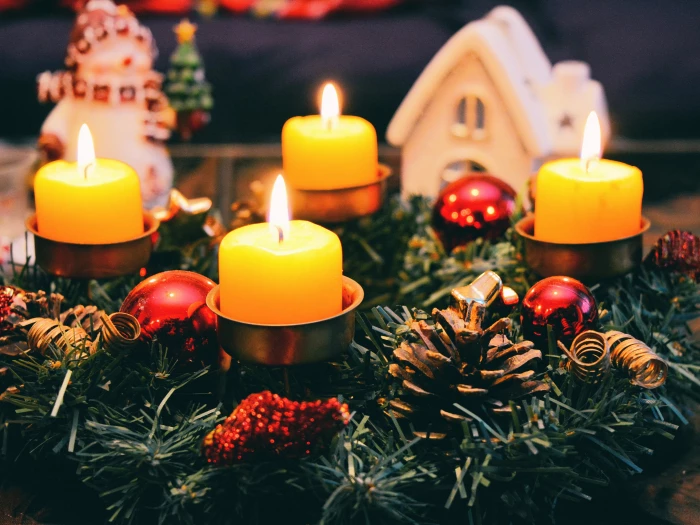 four yellow lighted candles