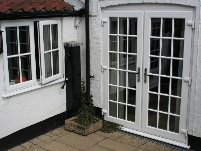 french doors with  white brick courtyard