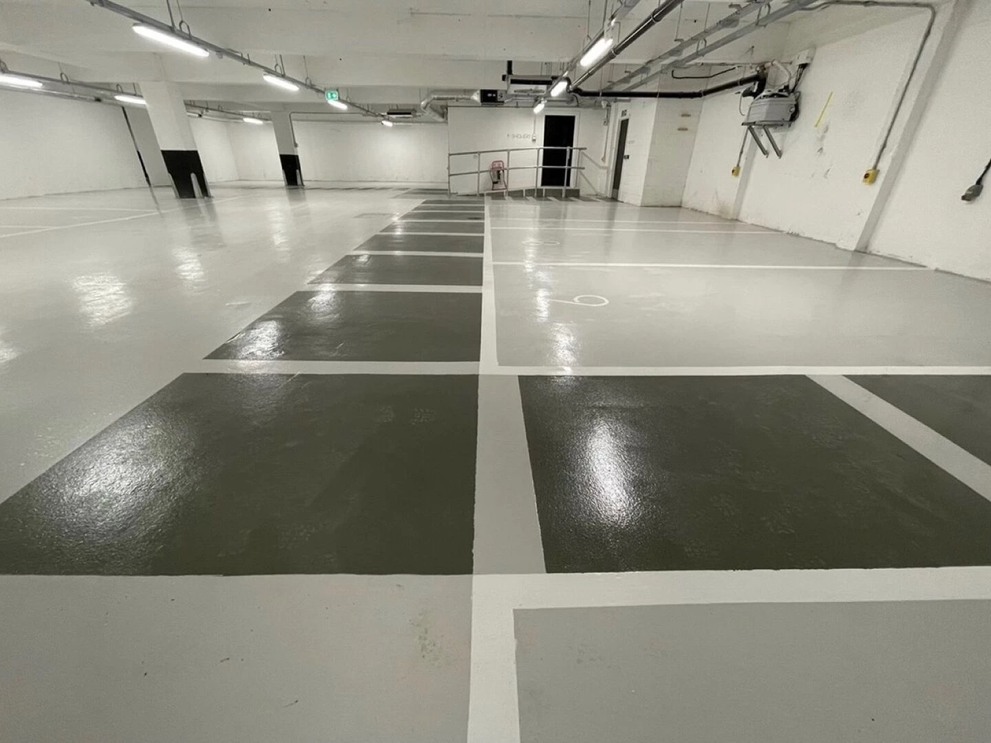 glossy underground parking lot with marked spaces