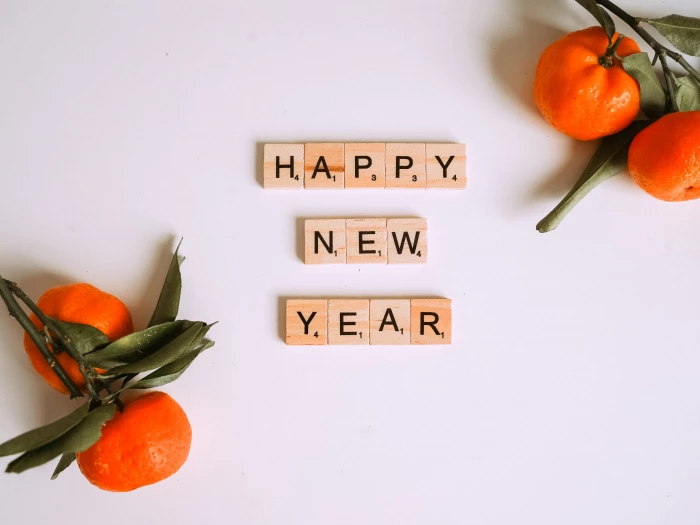 letter tiles beside mandarins