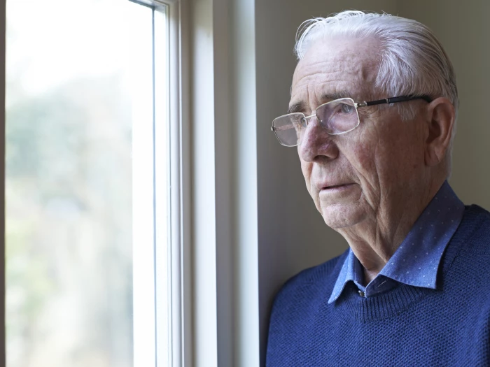 man looking out of window
