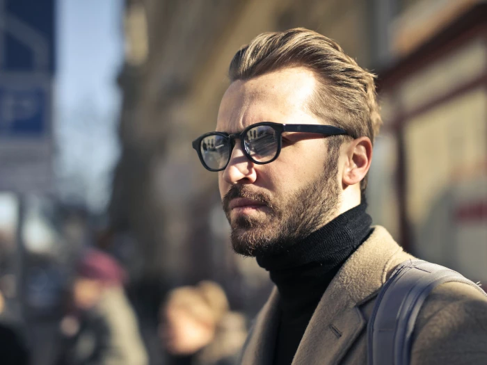 man with coat and glasses