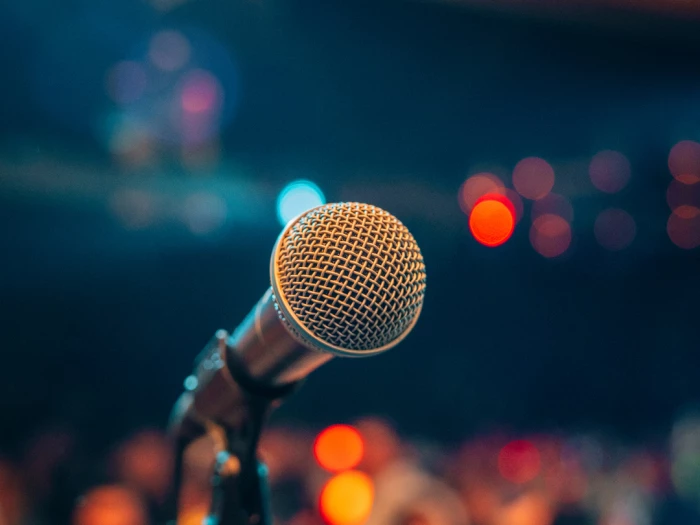 microphone highlighted against a sparkling background