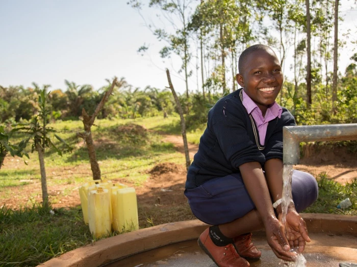 prossy nabiryo chair of st balikddembe schools health club shc using a new community water pump  copyright all we can